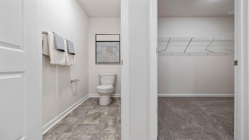 Bathroom with closet and toilet.