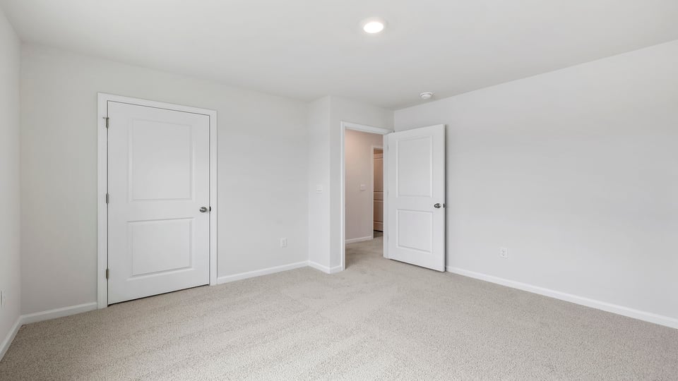 Bedroom with carpet and window.