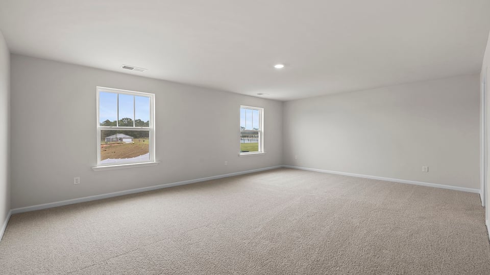 Bedroom with carpet and window.