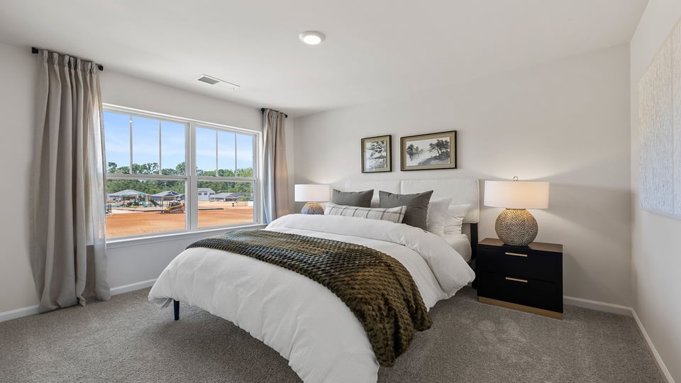 Bedroom with carpet and window.