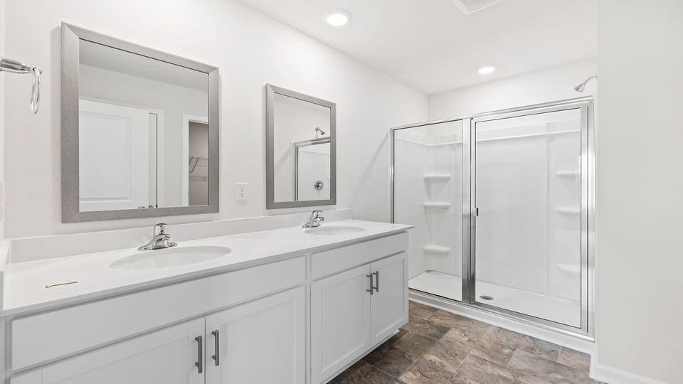 Bathroom ith vanity and walk in shower.
