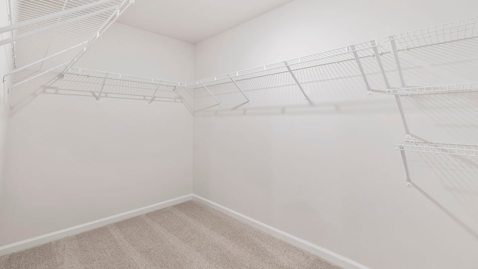 Walk in closet with shelves.