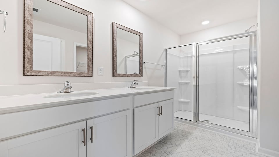 Bathroom with dual vanity and walk in shower.