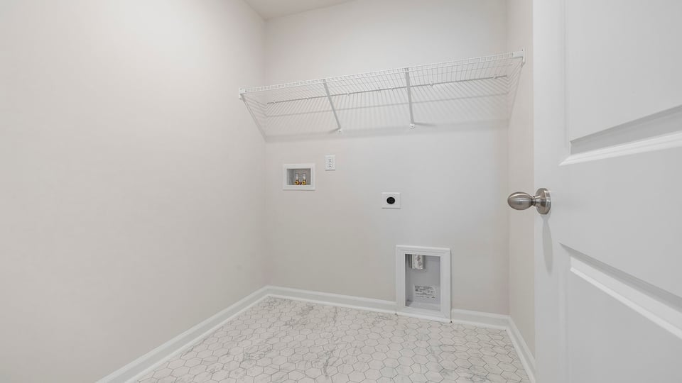 Walk in laundry with shelves.