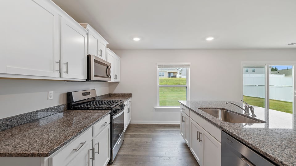 Kitchen and island with granite countertops.