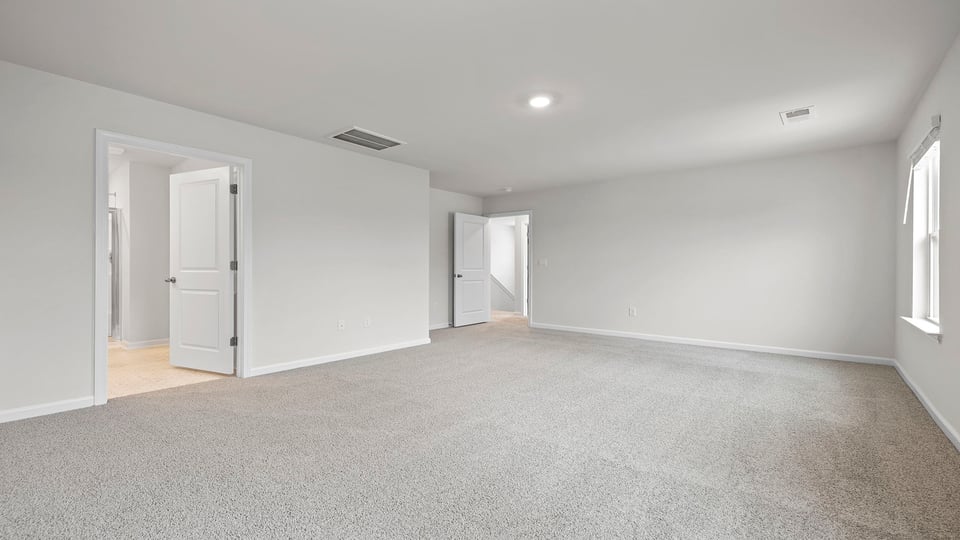 Bedroom with carpet and window.