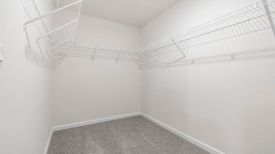 Walk in closet with shelves.