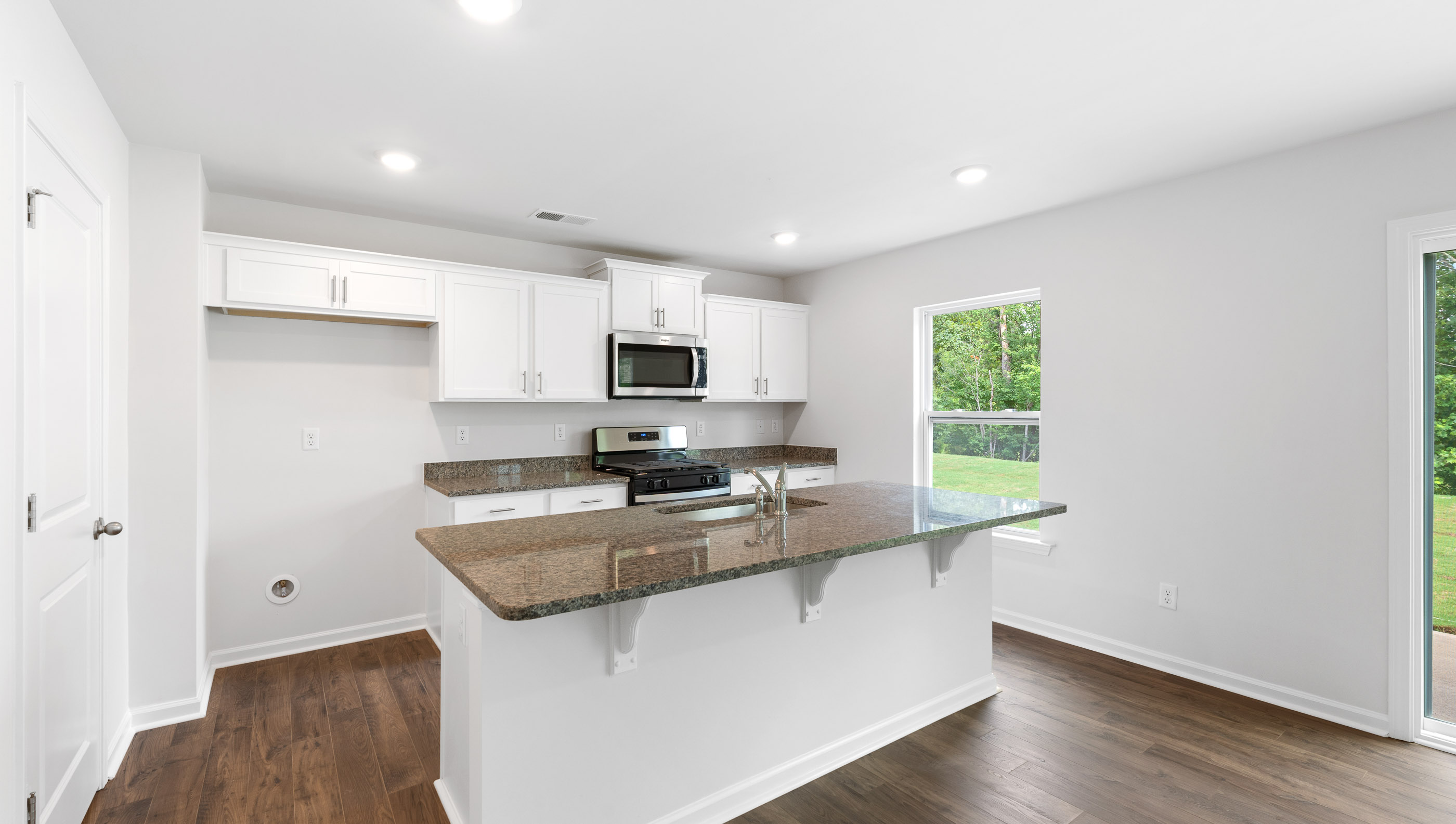 Kitchen and island with granite counter tops.