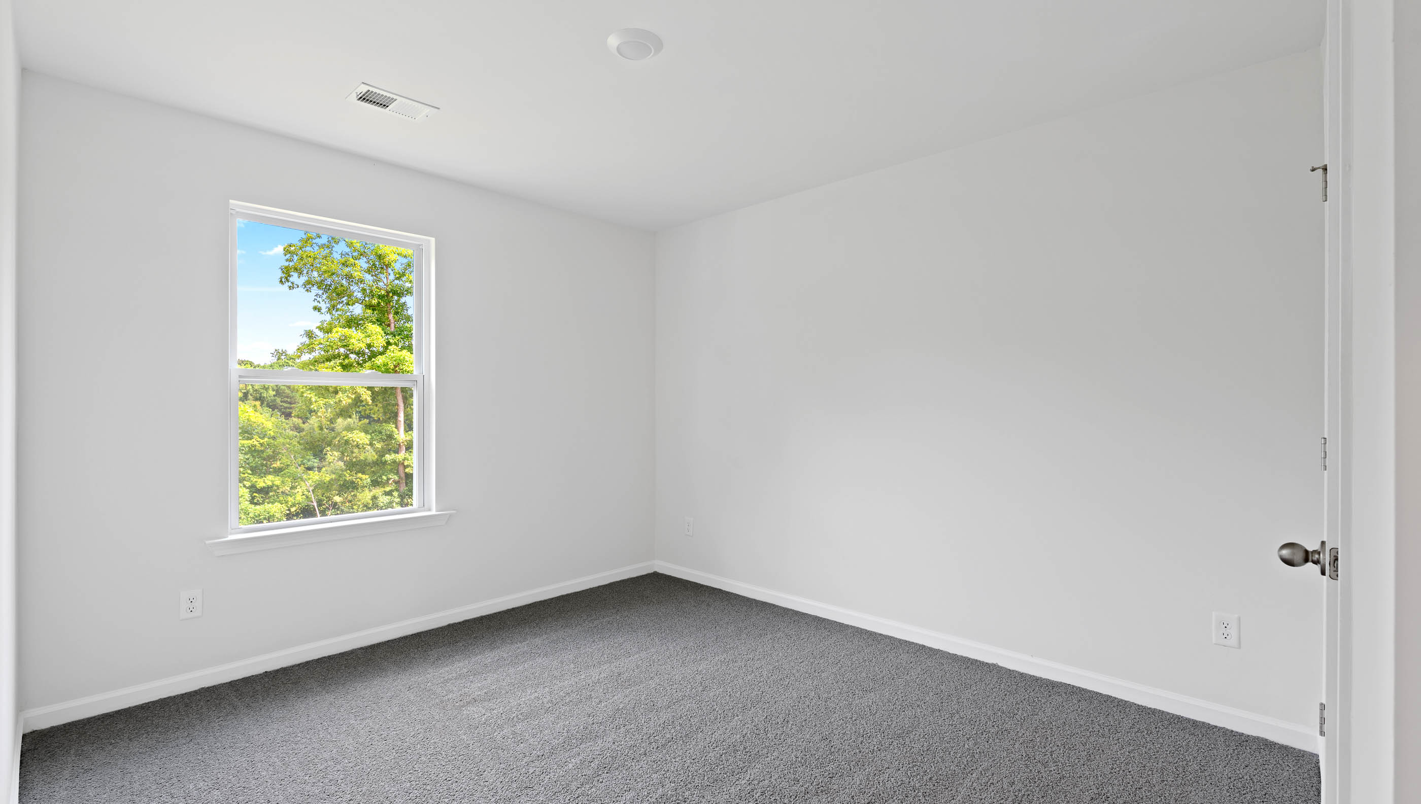 Bedroom with carpet and windows.