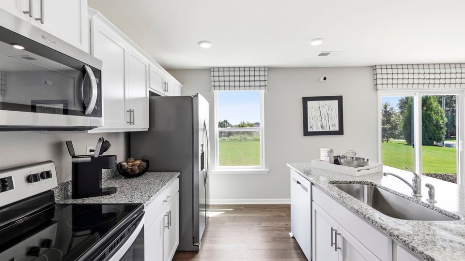 Kitchen and island with stainless steel appliances.