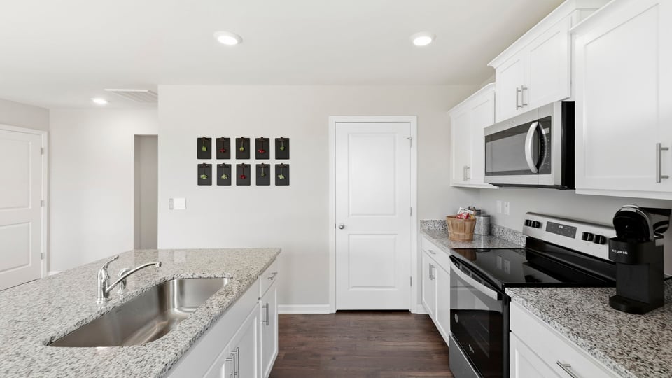 Kitchen and island with stainless steel appliances.