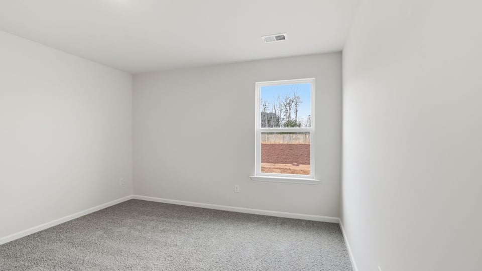 Bedroom with carpet and window
