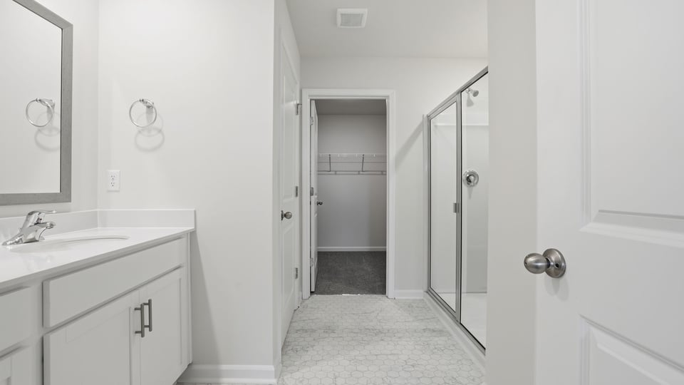Bathroom with double vanity and walk in shower.