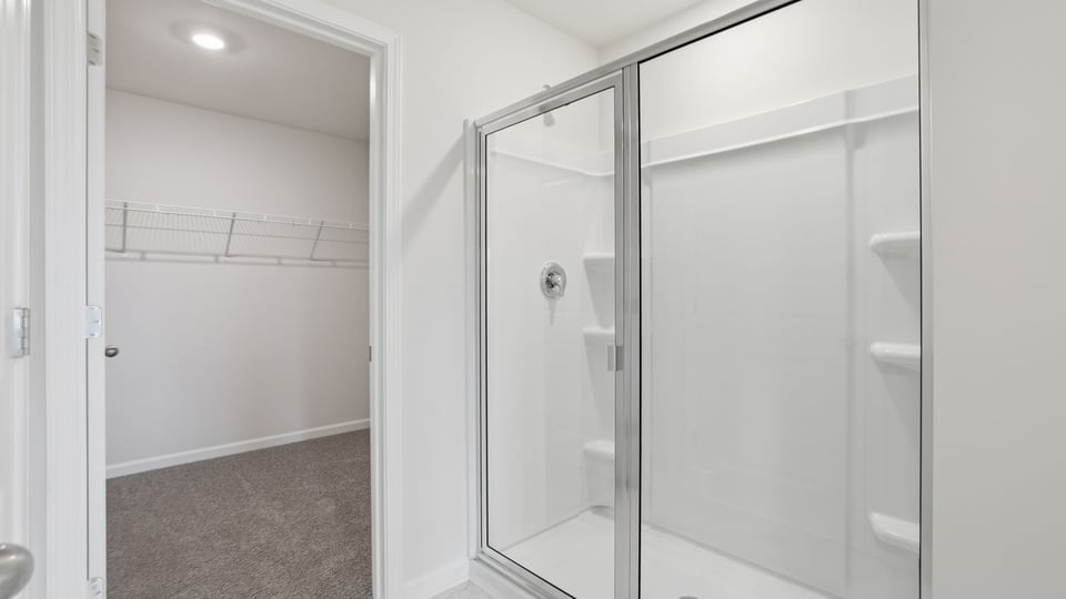 Bathroom with double vanity and walk in shower.