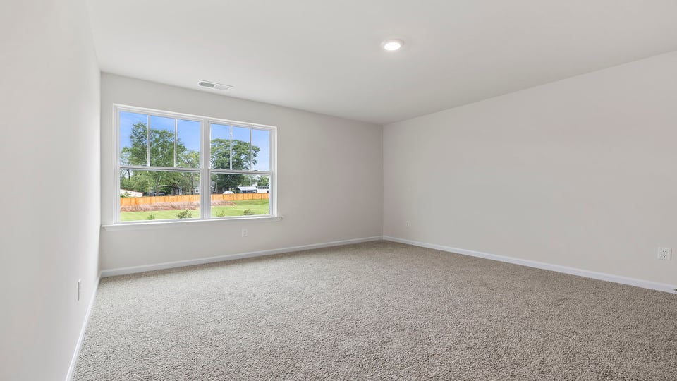 Bedroom with carpet and window.