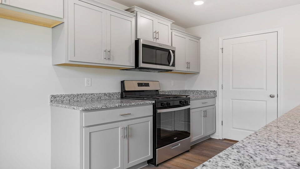 Kitchen with island and granite countertops.