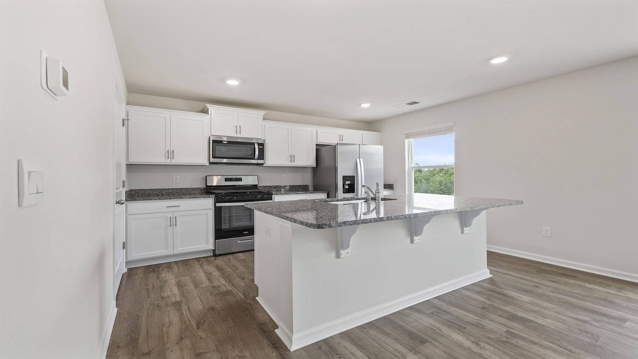 Kitchen and island with granite countertops.