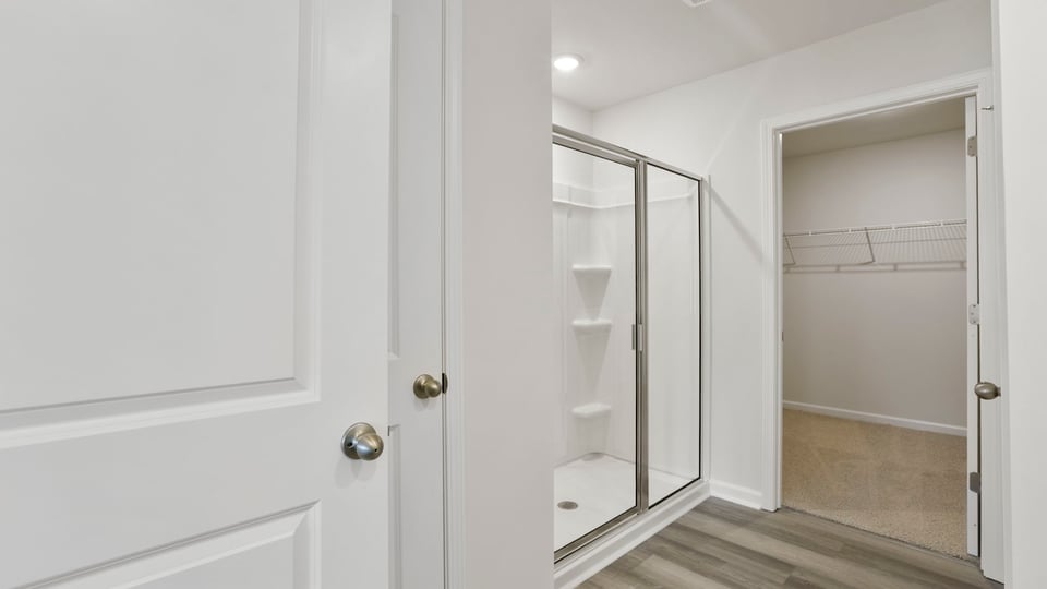Bathroom with walk in closet and shower.