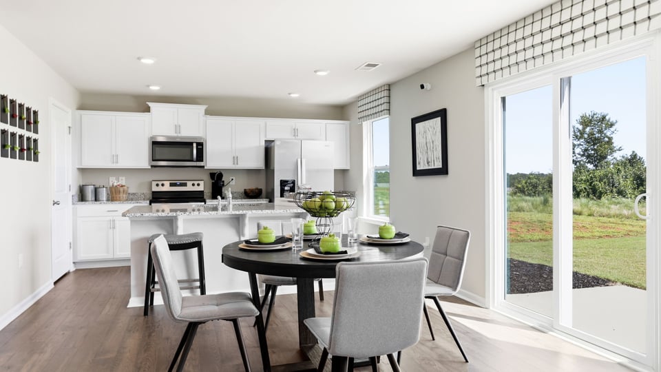Kitchen and island with stainless steel appliances.