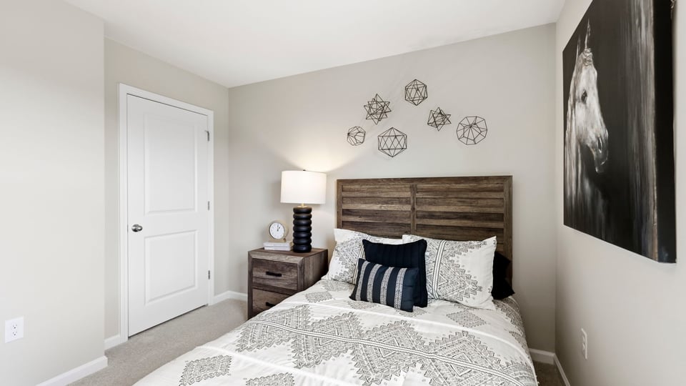 Bedroom with carpet and window.