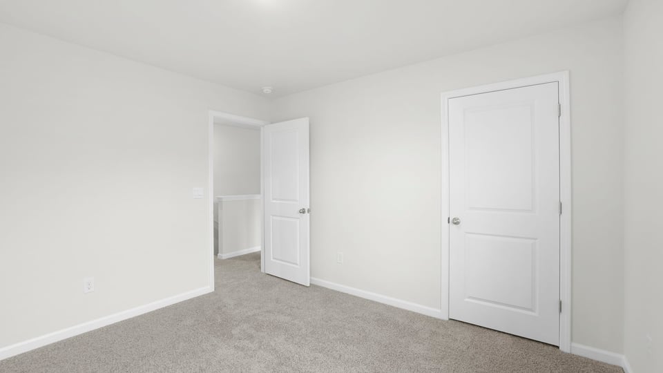 Bedroom with carpet and window.