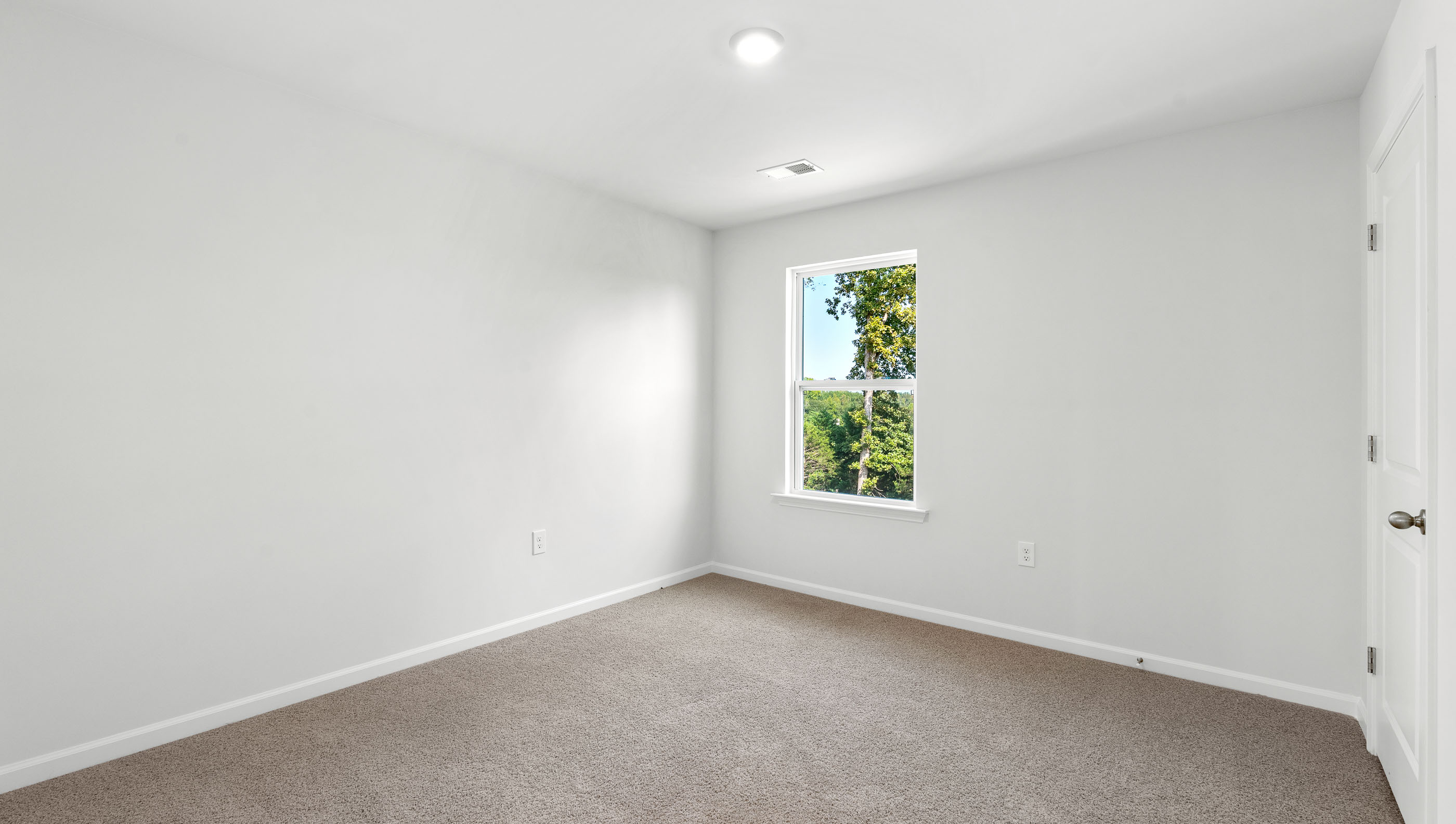 Bedroom with carpet and window.