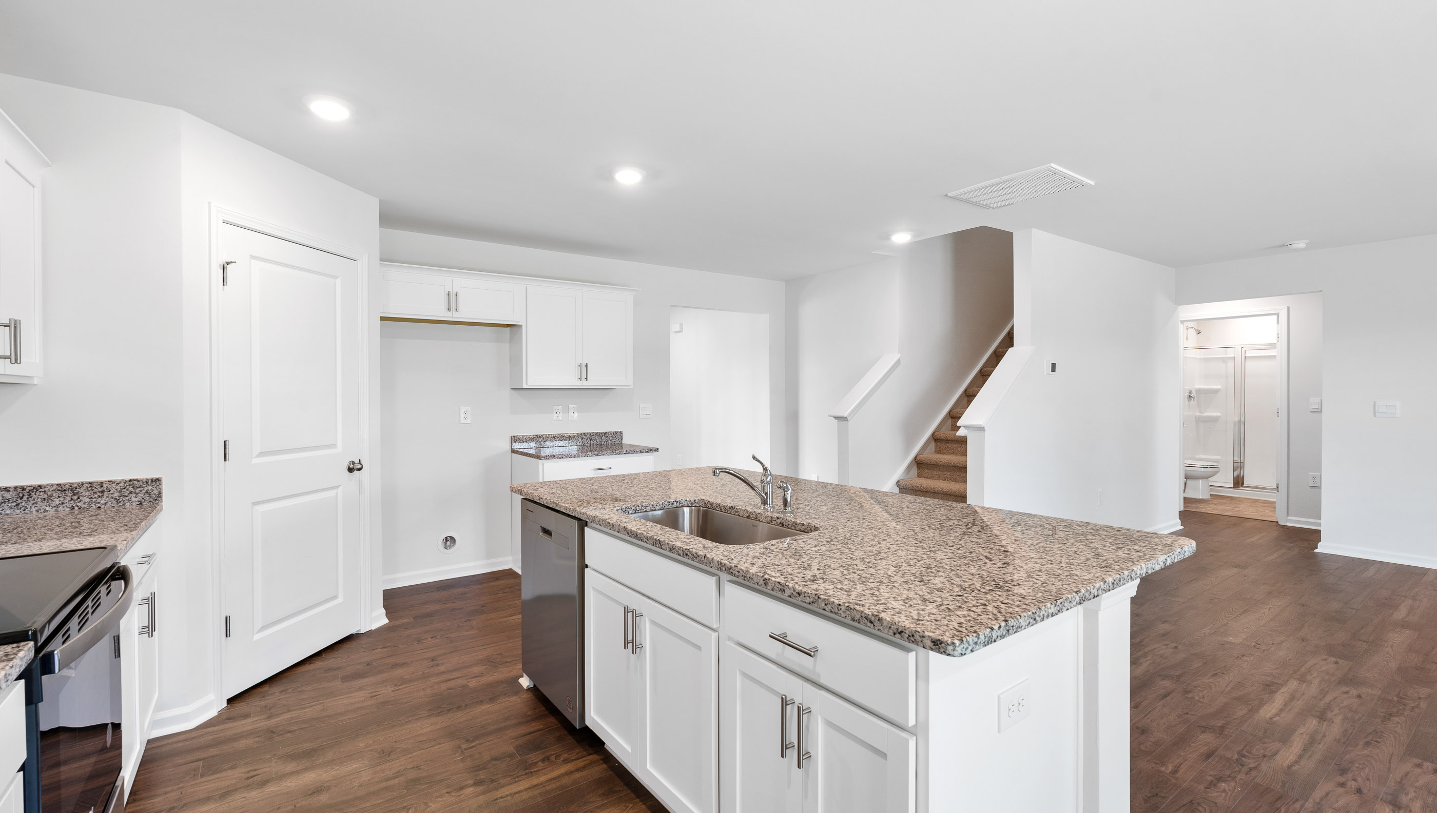 Kitchen with island and granite countertops.