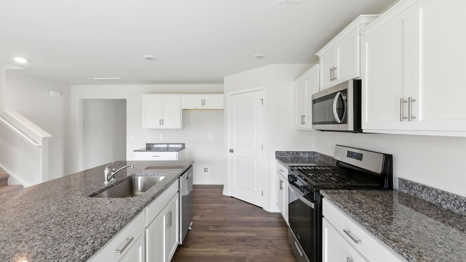 Kithcen with island and granite countertops.