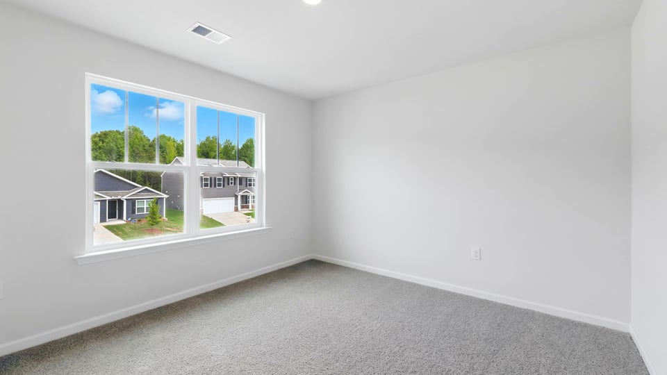 Bedroom with carpet and windows.