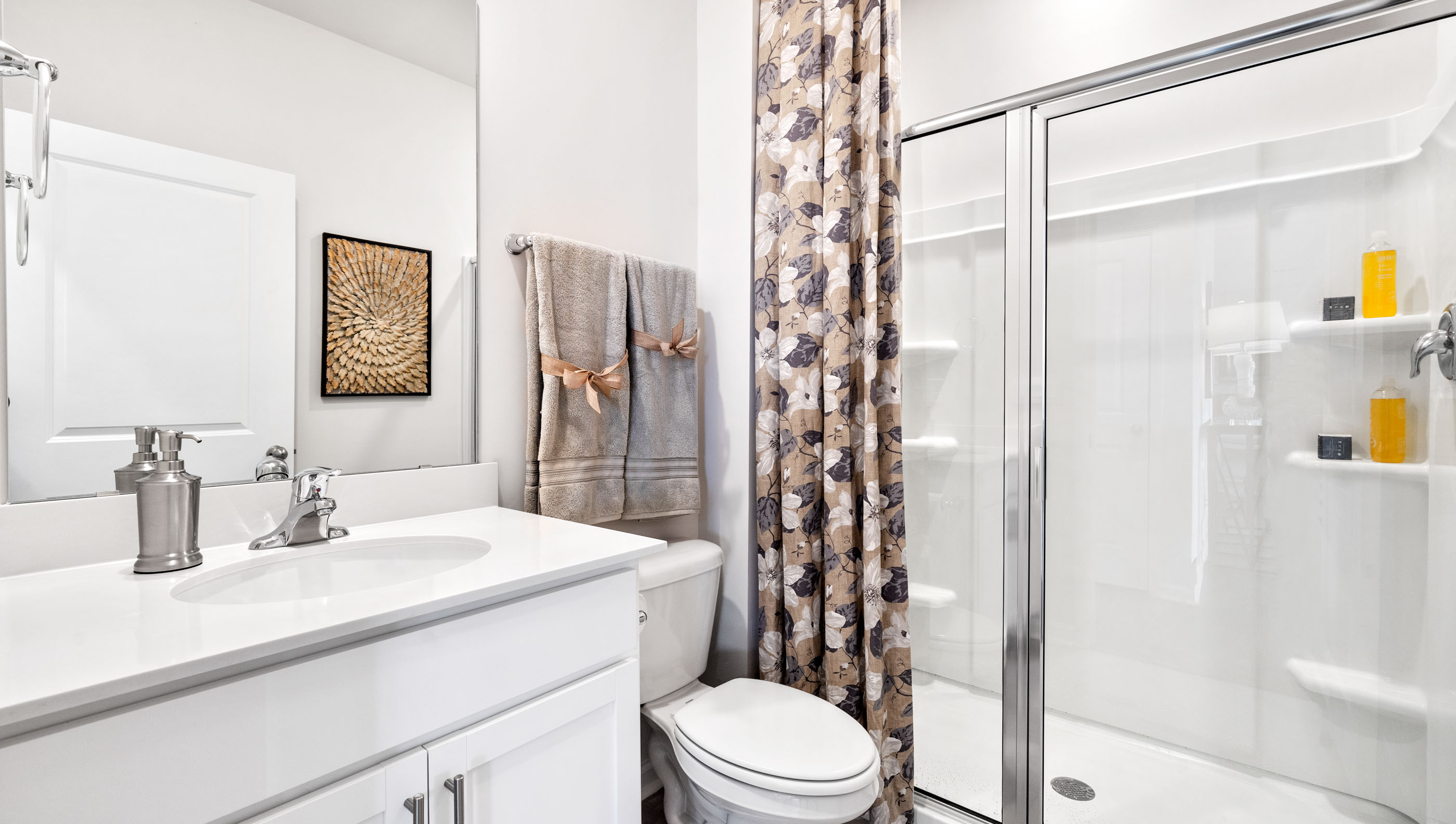 Bathroom with single vanity sink and walk in shower.