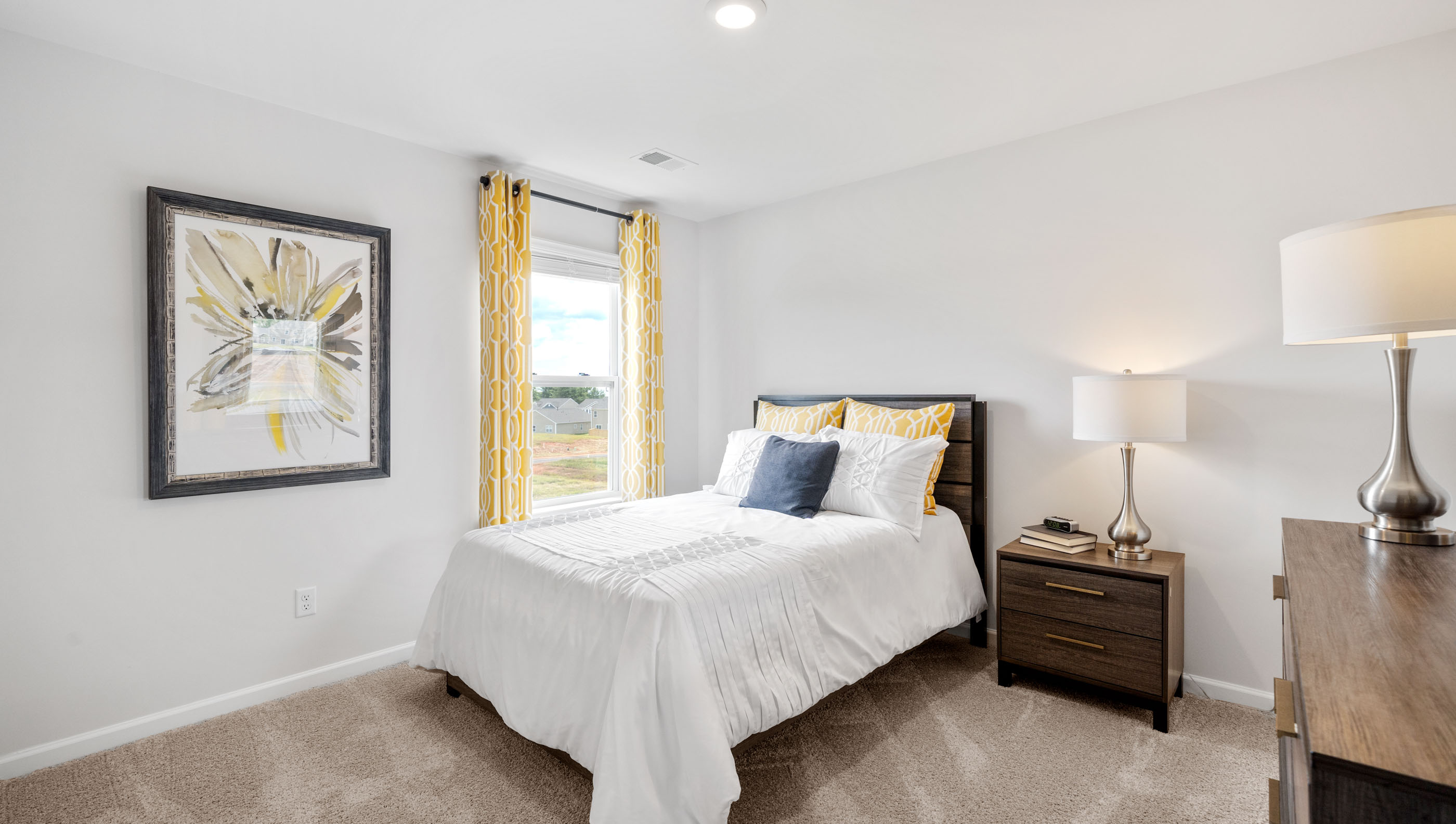 Bedroom with carpet and windows.