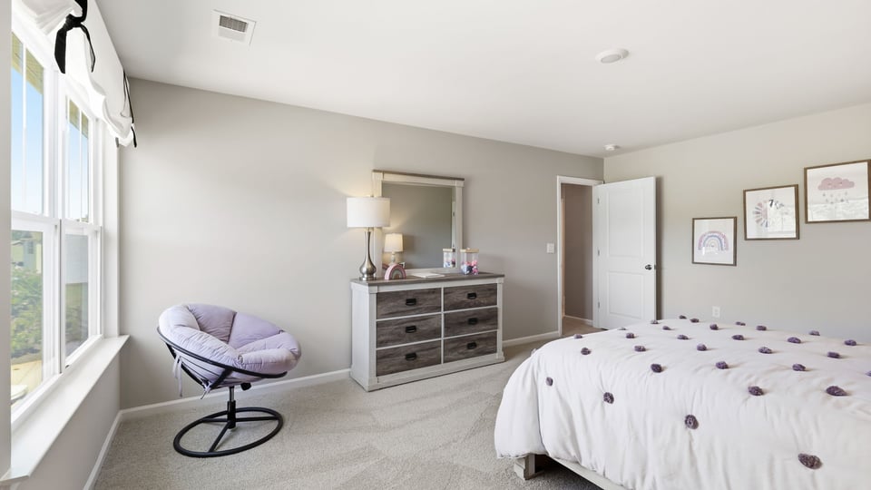 Bedroom with carpet and window.