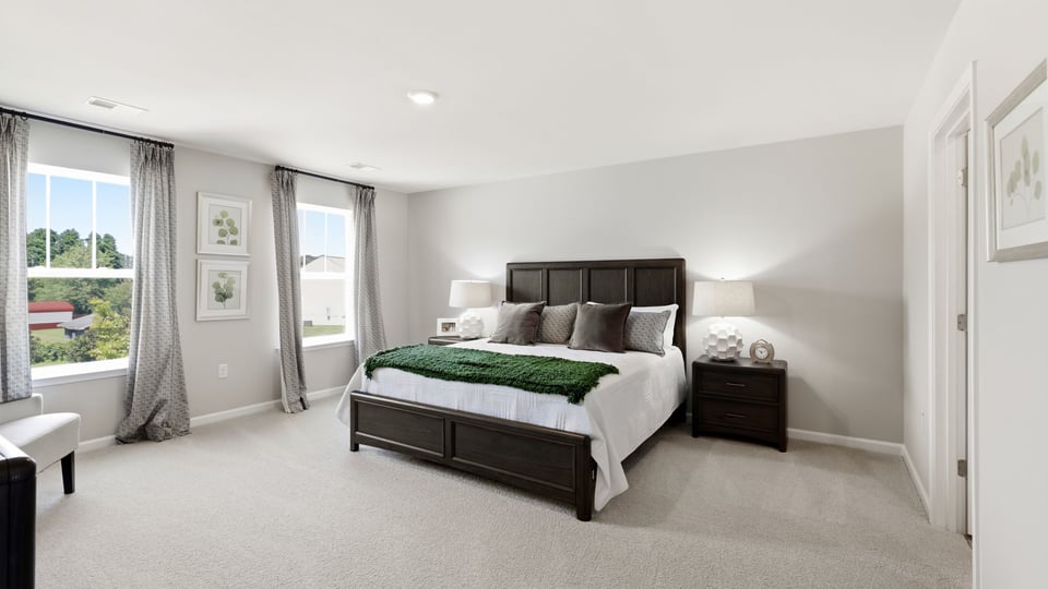 Bedroom with carpet and window.