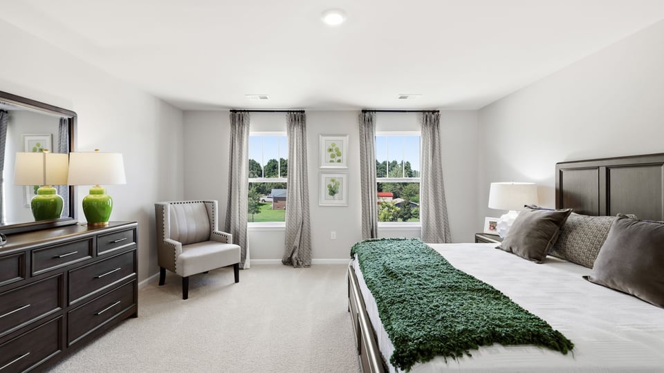 Bedroom with carpet and window.