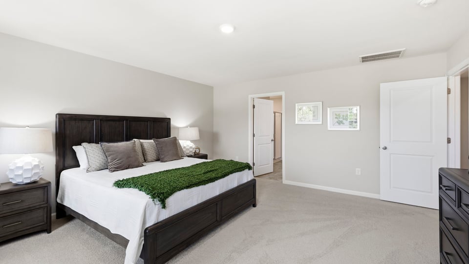 Bedroom with carpet and window.