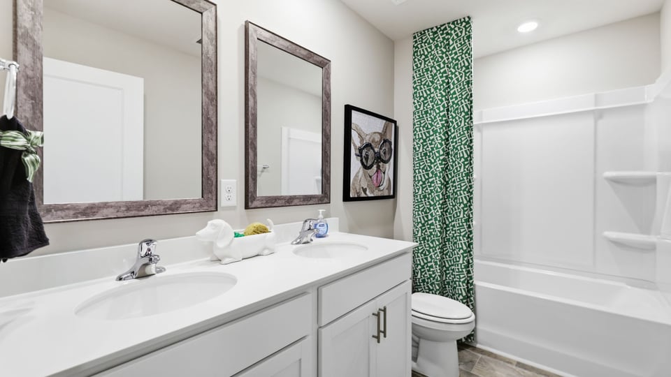 Bathroom with double vanity sink and bathtub.