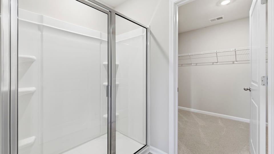 Bathroom with walk in closet and shower.