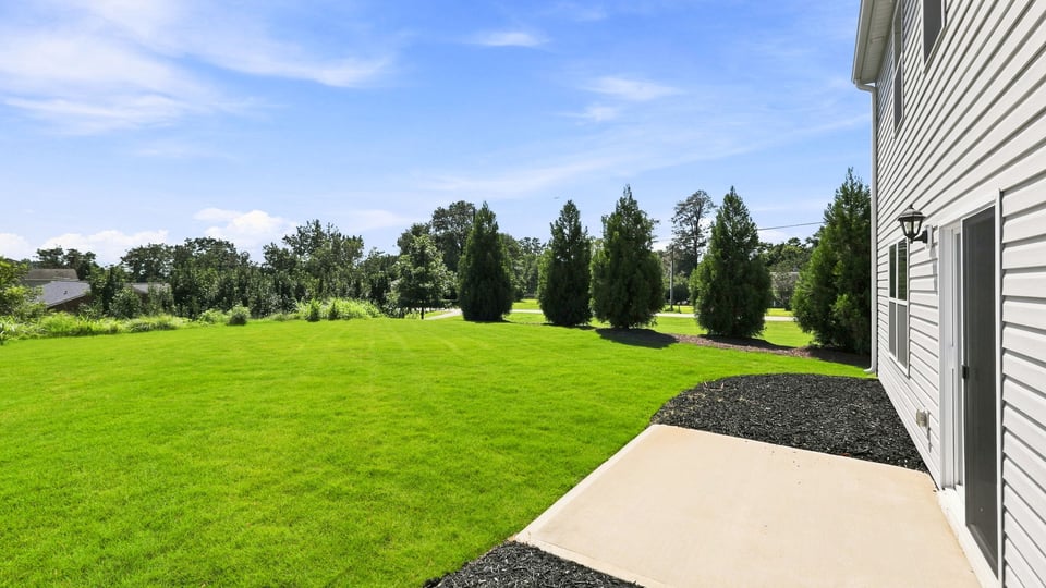 Back exterior of home with patio.