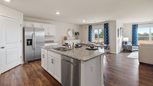Kitchen and island with view of family room.