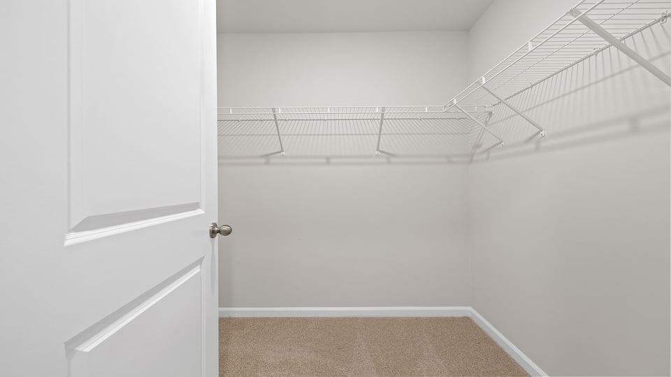 Walk in closet with shelves.