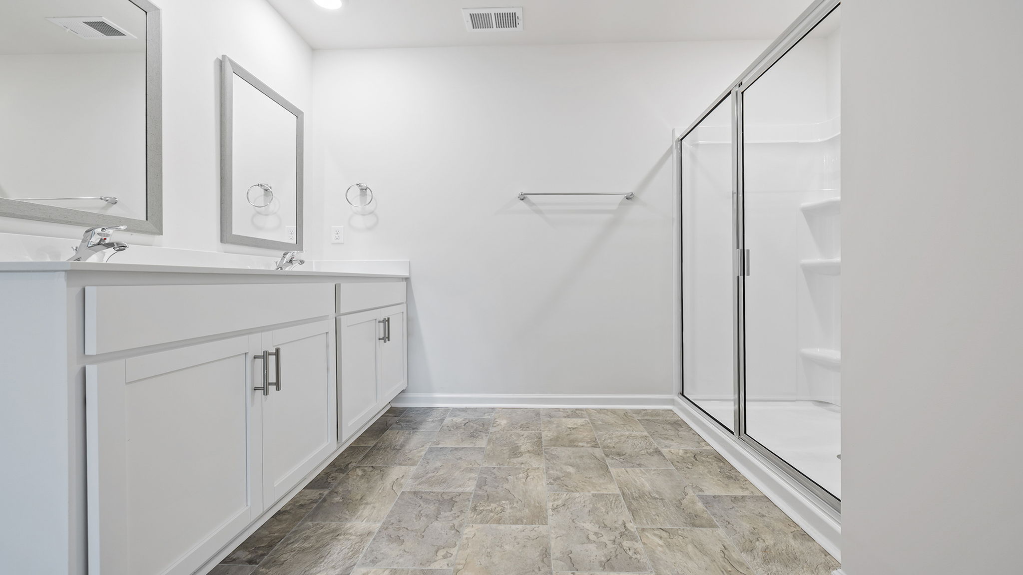 Bathroom with vanity and walk in shower.