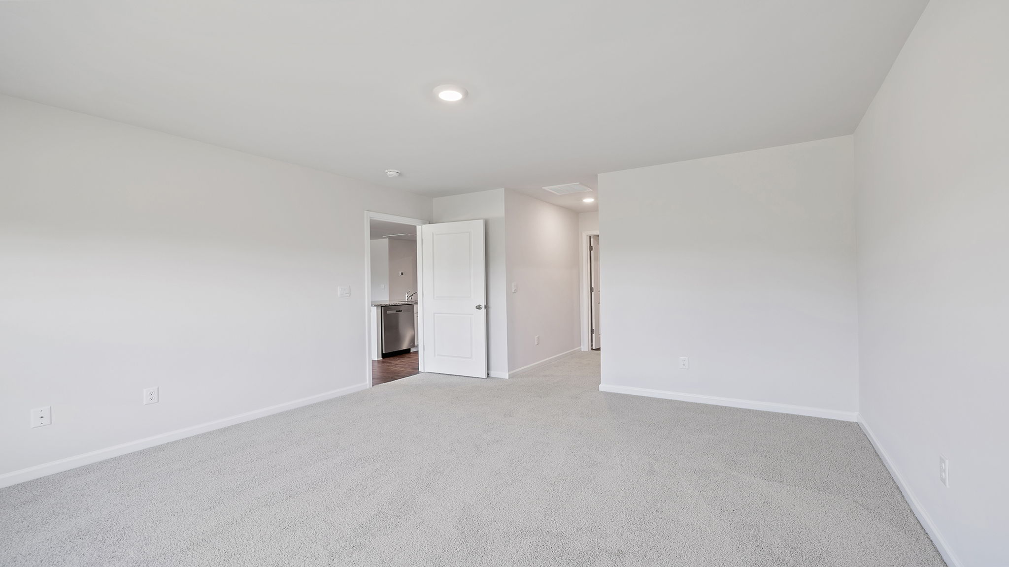 Bedroom with carpet and windows.