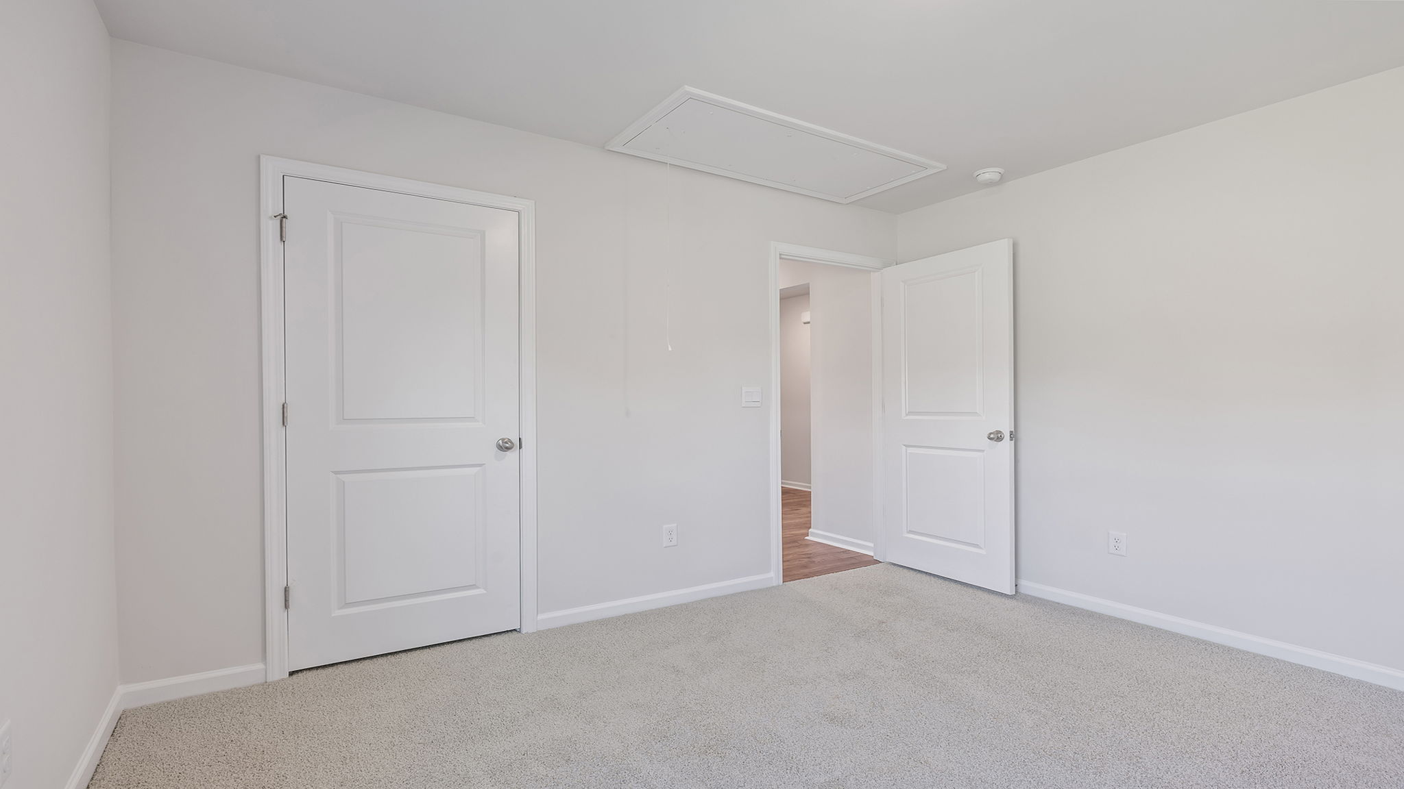 Bedroom with carpet and windows.