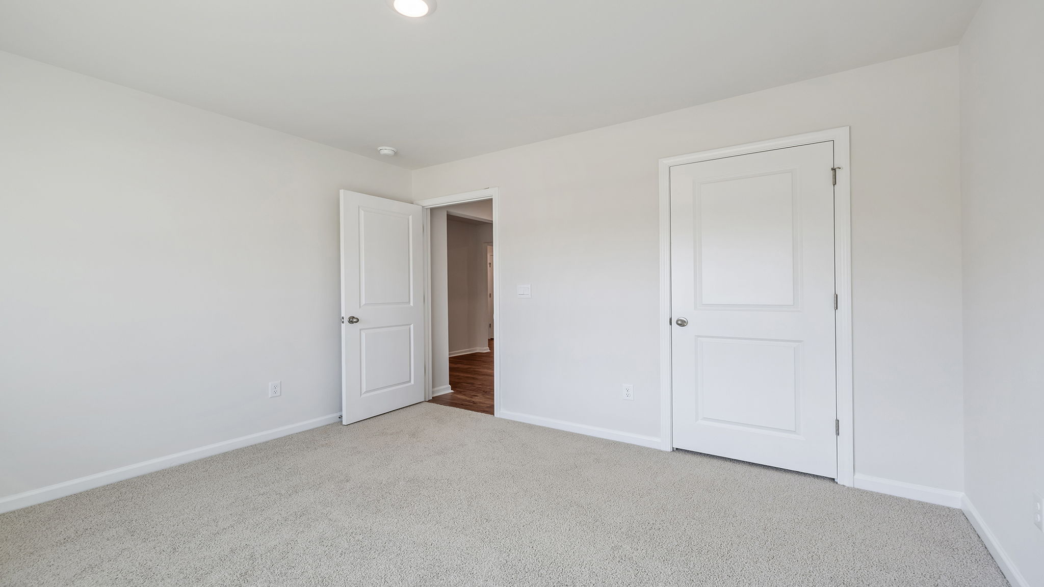 Bedroom with carpet and windows.