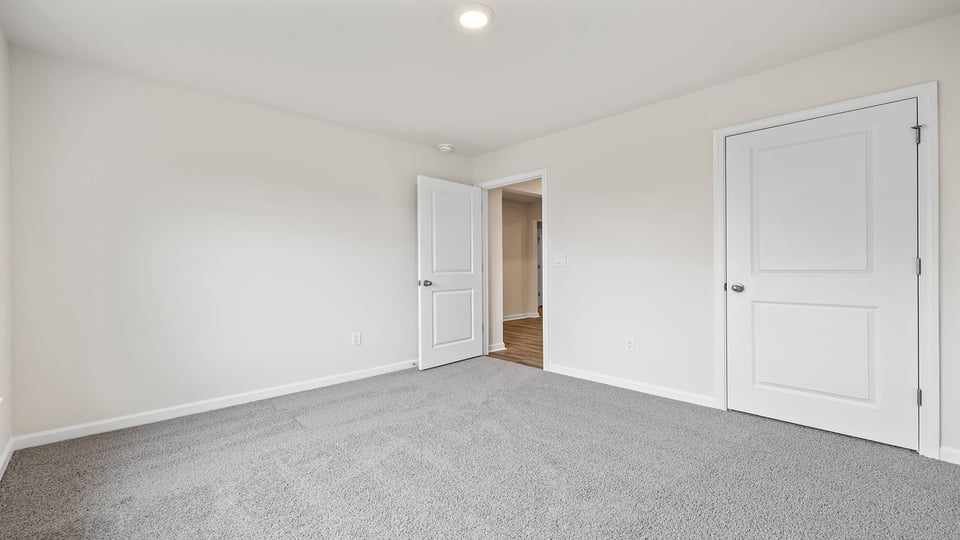 Bedroom with carpet and window.