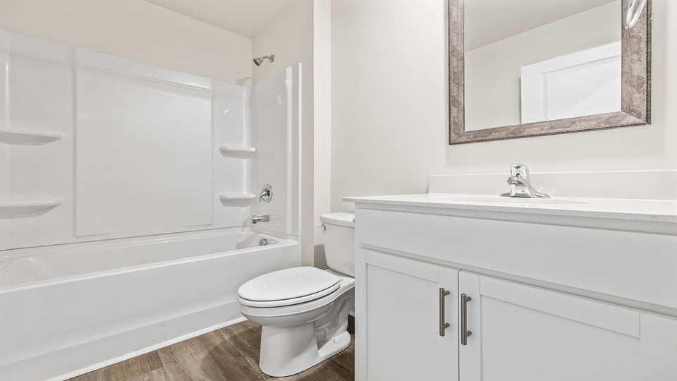 Bathroom with tub and single vanity sink.