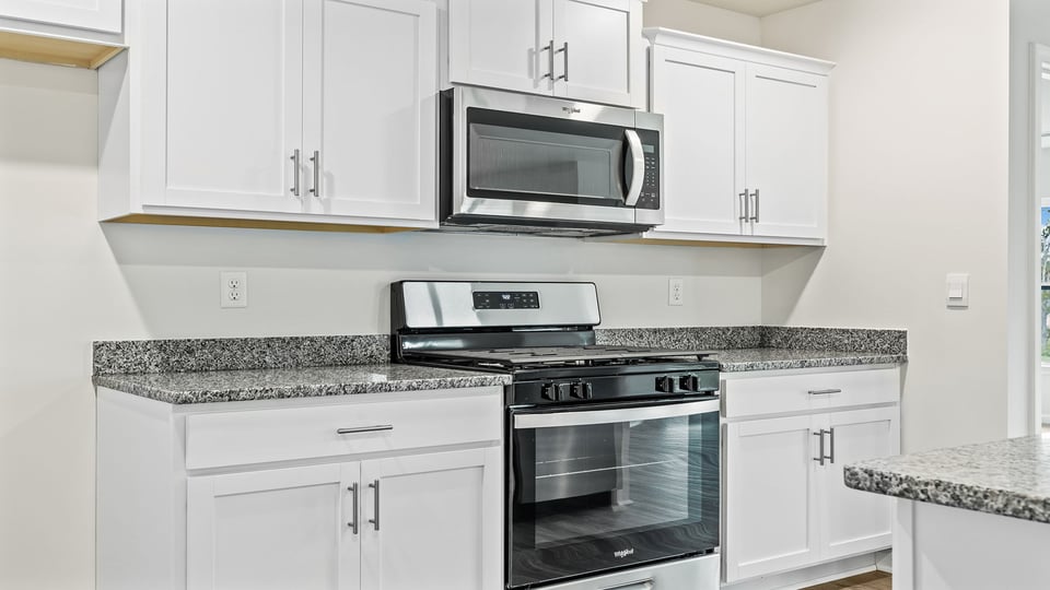 Kitchen and island with stainless steel appliances.
