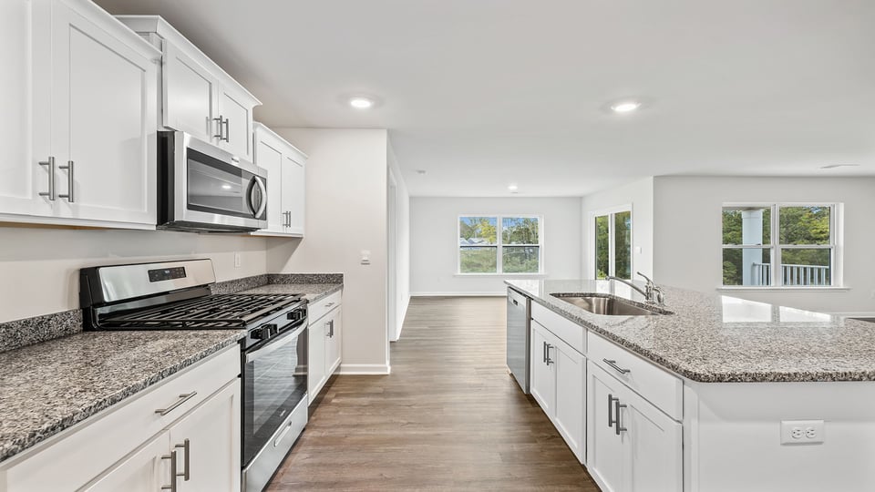 Kitchen and island with stainless steel appliances.