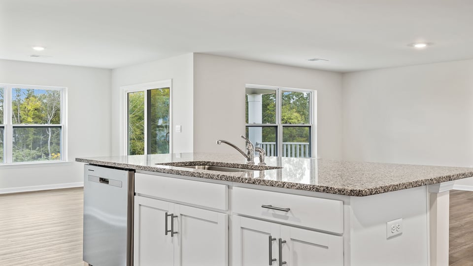 Kitchen and island with stainless steel appliances.