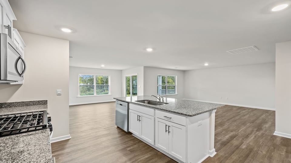 Kitchen and island with stainless steel appliances.